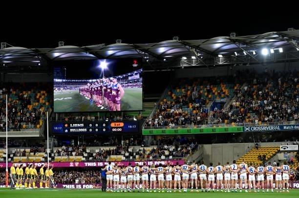 The teams line up for the national anthem ahead of the AFL 1st Semi Final match between the Brisbane Lions and the Western Bulldogs at The Gabba on...