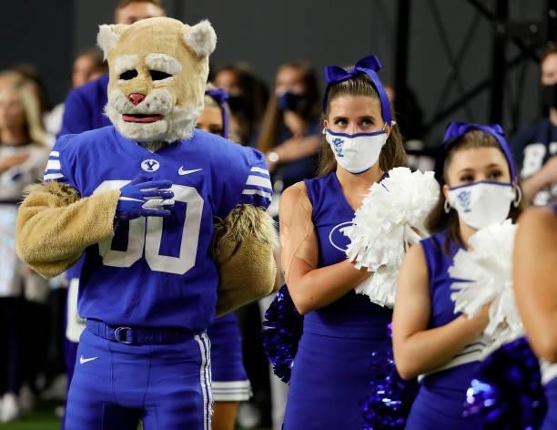 Brigham Young Cougars mascot Cosmo and cheerleaders stand on the team's sideline as the American national anthem is performed before the Good Sam...