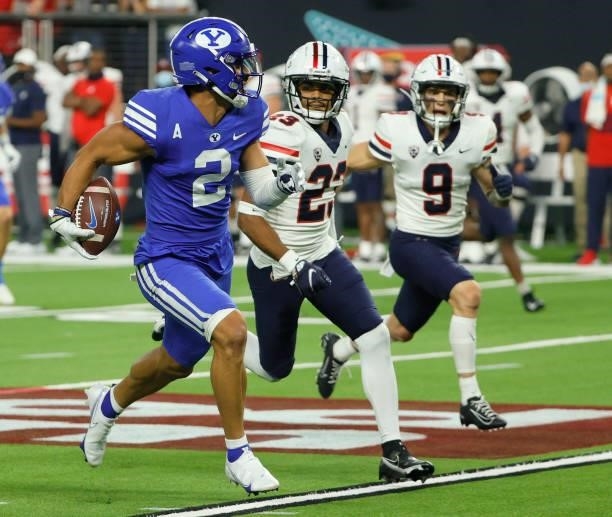 Wide receiver Neil Pau'u of the Brigham Young Cougars runs for a touchdown against cornerback Malik Hausman and safety Gunner Maldonado of the...