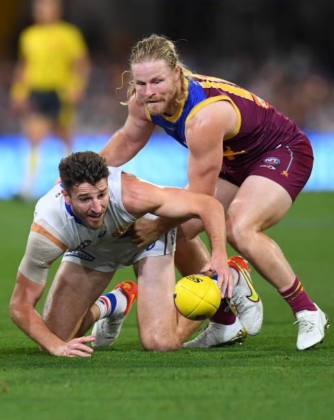 Marcus Bontempelli of the Bulldogs and Daniel Rich of the Lions compete for the ball during the AFL 1st Semi Final match between the Brisbane Lions...
