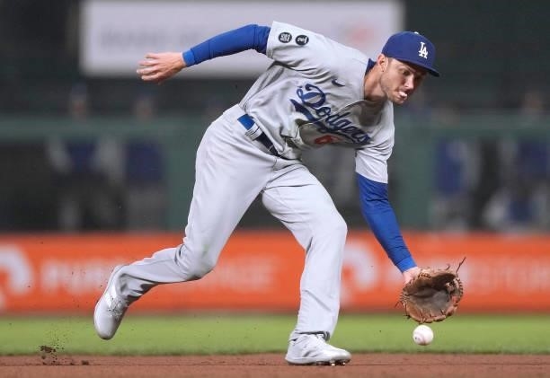 Trea Turner of the Los Angeles Dodgers goes down to field a ground ball off the bat of Austin Slater of the San Francisco Giants in the bottom of the...