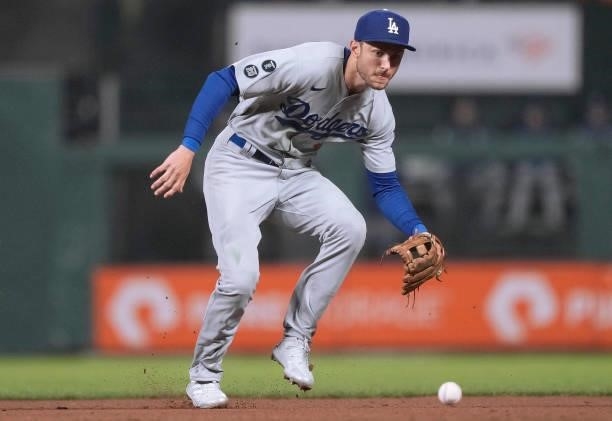Trea Turner of the Los Angeles Dodgers goes down to field a ground ball off the bat of Austin Slater of the San Francisco Giants in the bottom of the...