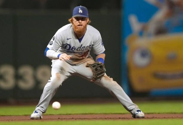 Justin Turner of the Los Angeles Dodgers goes down for a ground ball off the bat of Kris Bryant of the San Francisco Giants in the bottom of the...