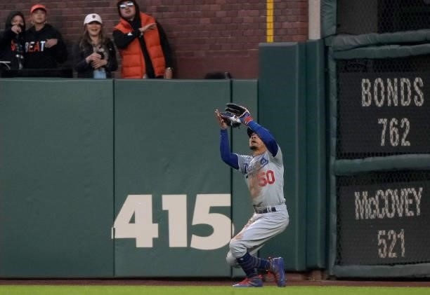 Mookie Betts of the Los Angeles Dodgers catches a fly ball off the bat of Brandon Belt of the San Francisco Giants in the bottom of the fourth inning...