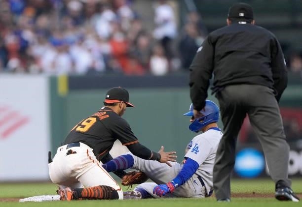Mookie Betts of the Los Angeles Dodgers attempting to steal gets tagged out at second base by Thairo Estrada of the San Francisco Giants in the top...