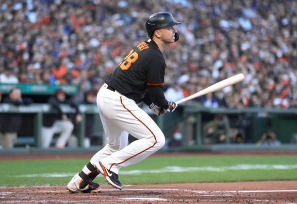 Buster Posey of the San Francisco Giants hits an RBI double scoring Kris Bryant against the Los Angeles Dodgers in the bottom of the first inning at...