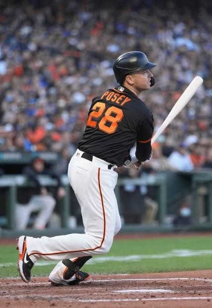 Buster Posey of the San Francisco Giants hits an RBI double scoring Kris Bryant against the Los Angeles Dodgers in the bottom of the first inning at...