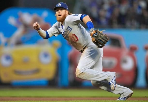 Justin Turner of the Los Angeles Dodgers reacts to a ball that gets past him for a double off the bat of Mauricio Dubon of the San Francisco Giants...