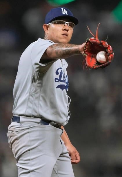 Julio Urias of the Los Angeles Dodgers catches a new baseball thrown into the game against the San Francisco Giants in the bottom of the six inning...