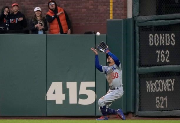 Mookie Betts of the Los Angeles Dodgers catches a fly ball off the bat of Brandon Belt of the San Francisco Giants in the bottom of the fourth inning...