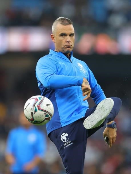 Robbie Williams of England warms up prior to the Soccer Aid for Unicef 2021 match between England and Soccer Aid World XI at Etihad Stadium on...
