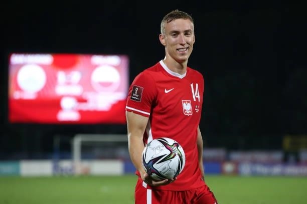 Adam Buksa of Poland smiles as he holds the matchball following his hat-trick in the 2022 FIFA World Cup Qualifier match between San Marino and...