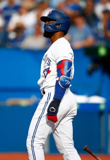 Teoscar Hernandez of the Toronto Blue Jays watches the ball clear the fence after hitting his 100th career home run during a MLB game against the...