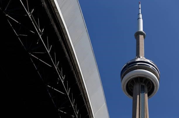 The CN Tower is visible past the open roof of the Rogers Centre prior to a MLB game between the Toronto Blue Jays and the Oakland Athletics at Rogers...