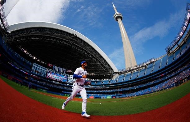 Lourdes Gurriel Jr. #13 of the Toronto Blue Jays runs to the dugout prior to a MLB game against the Oakland Athletics at Rogers Centre on September...