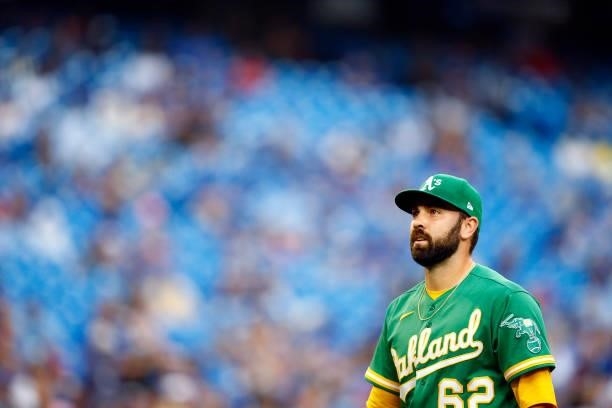 Lou Trivino of the Oakland Athletics walks to the dugout after being pulled from the game during a MLB game against the Toronto Blue Jays at Rogers...