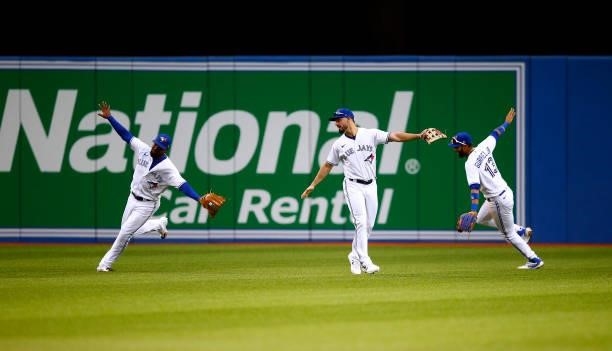 Teoscar Hernandez, Randal Grichuk and Lourdes Gurriel Jr. #13 of the Toronto Blue Jays celebrate the win following a MLB game against the Oakland...