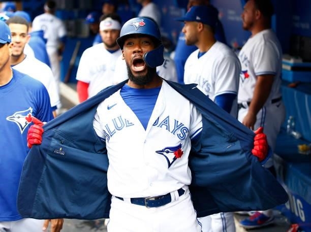 Teoscar Hernandez of the Toronto Blue Jays celebrates after hitting his 100th career home run during a MLB game against the Oakland Athletics at...