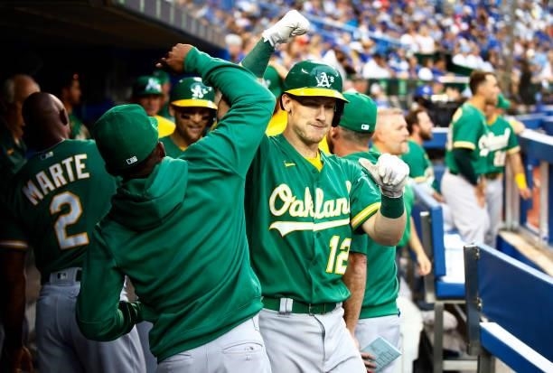 Sean Murphy of the Oakland Athletics celebrates with teammates after hitting a 2 run home run in the ninth inning during a MLB game against the...