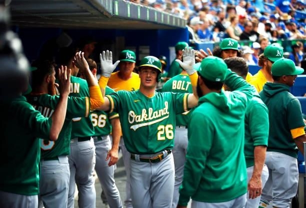Matt Chapman of the Oakland Athletics celebrates with teammates after hitting a home run during a MLB game against the Toronto Blue Jays at Rogers...