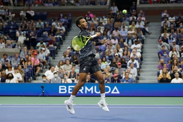 Felix Auger-Aliassime of Canada returns the ball against Frances Tiafoe of the United States during his Men’s Singles round of 16 match on Day Seven...