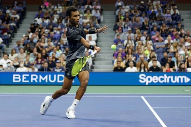 Felix Auger-Aliassime of Canada returns the ball against Frances Tiafoe of the United States during his Men’s Singles round of 16 match on Day Seven...