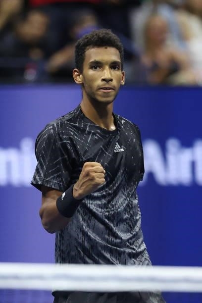 Felix Auger-Aliassime of Canada reacts to winning match point against Frances Tiafoe of the United States during his Men’s Singles round of 16 match...