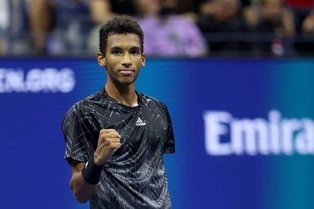 Felix Auger-Aliassime of Canada reacts to winning match point against Frances Tiafoe of the United States during his Men’s Singles round of 16 match...