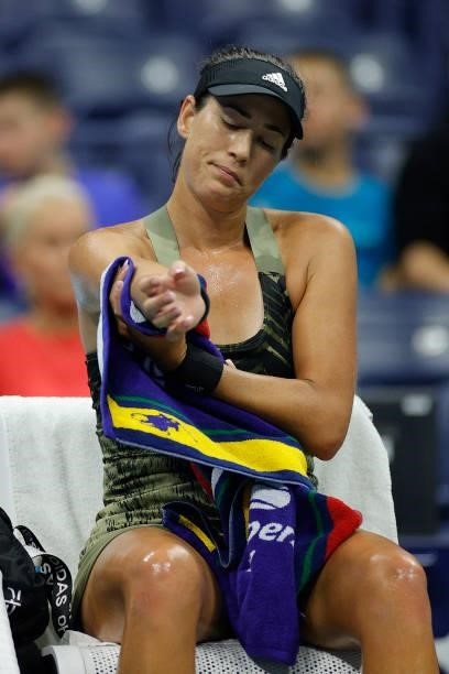 Garbine Muguruza of Spain dries her arm while sitting between games against Barbora Krejcikova of Czech Republic during their Women's Singles fourth...