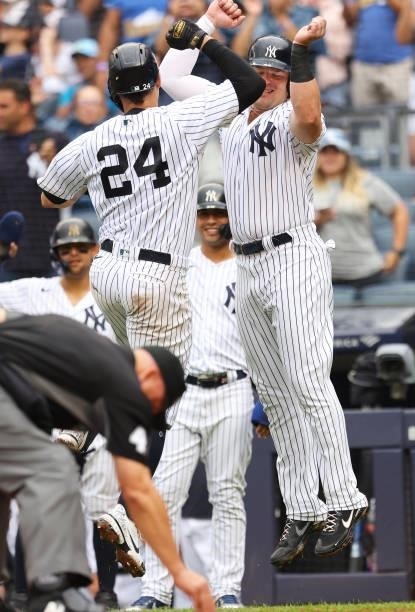 Gary Sanchez of the New York Yankees celebrates with Luke Voit after he hit a grand slam home run against the Baltimore Orioles during the second...