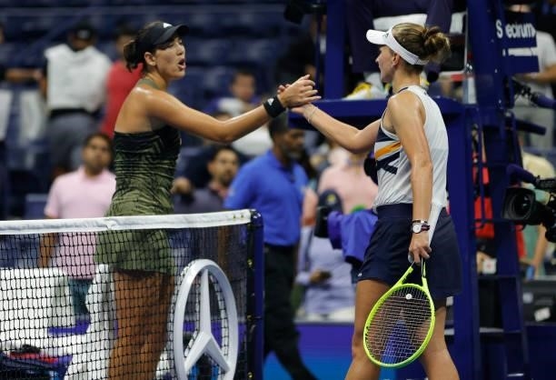 Garbine Muguruza of Spain and Barbora Krejcikova of Czech Republic meet at center court after Krejcikova won during their Women's Singles fourth...