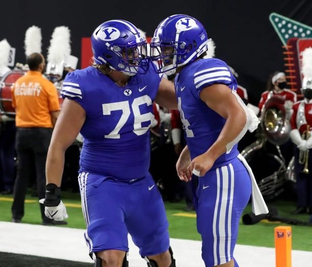 Offensive lineman Harris LaChance and running back Lopini Katoa of the Brigham Young Cougars celebrate after Katoa scored a two-point conversion...