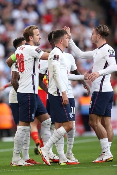 Harry Kane of England celebrates after scoring their team's second goal with teammates Jack Grealish and Mason Mount during the 2022 FIFA World Cup...