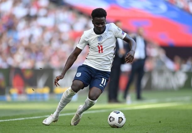 Bukayo Saka of England runs with the ball during the 2022 FIFA World Cup Qualifier match between England and Andorra at Wembley Stadium on September...