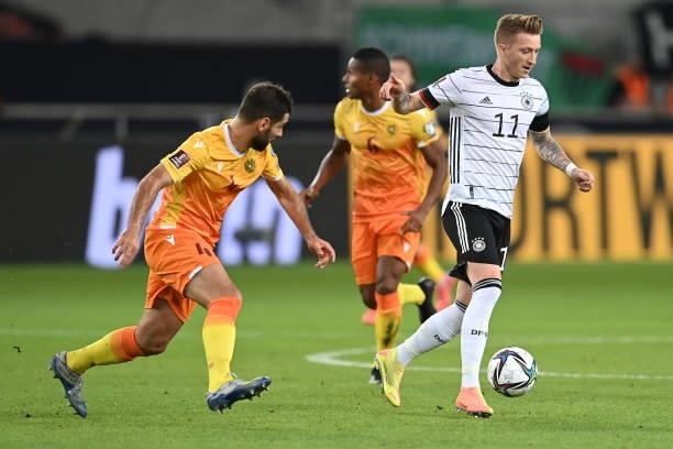 Marco Reus of Germany is tackled by Taron Voskanyan of Armenia during the 2022 FIFA World Cup Qualifier match between Germany and Armenia at Mercedes...