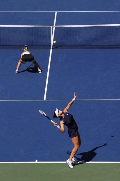Caroline Dolehide of the United States and Storm Sanders of Australia serve against Shuai Zhang of China and Samantha Stosur of Australia during...