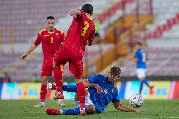 Andrija Raznatovic of Montenegro competes for the ball with Lorenzo Lucca of Italy during the UEFA European Under-21 Championship Qualifier between...