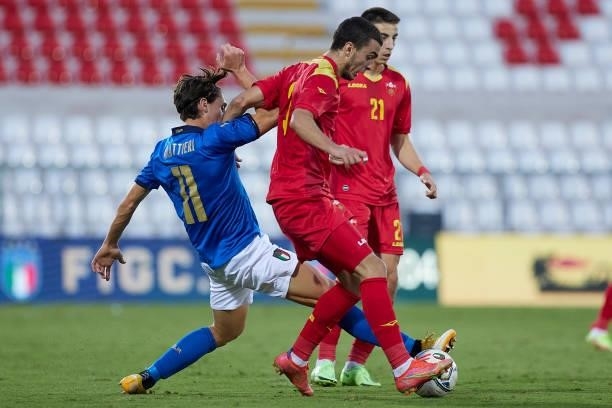 Samuele Mulattieri of Italy competes for the ball with Andrija Raznatovic of Montenegro during the UEFA European Under-21 Championship Qualifier...