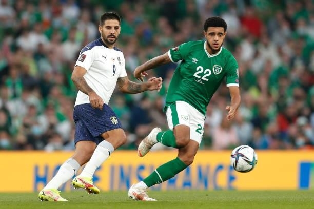 Aleksandar Mitrovic of Serbia battles for possession with Andrew Omobamidele of Republic of Ireland during the 2022 FIFA World Cup Qualifier match...