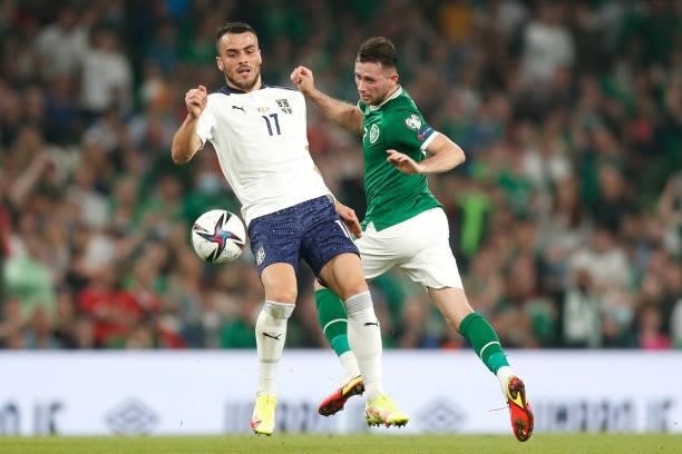 Filip Kostic of Serbia battles for possession with Alan Browne of Republic of Ireland during the 2022 FIFA World Cup Qualifier match between Republic...