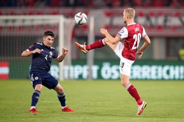 Konrad Laimer of Austria controls the ball as Billy Gilmour of Scotland looks on during the 2022 FIFA World Cup Qualifier match between Austria and...