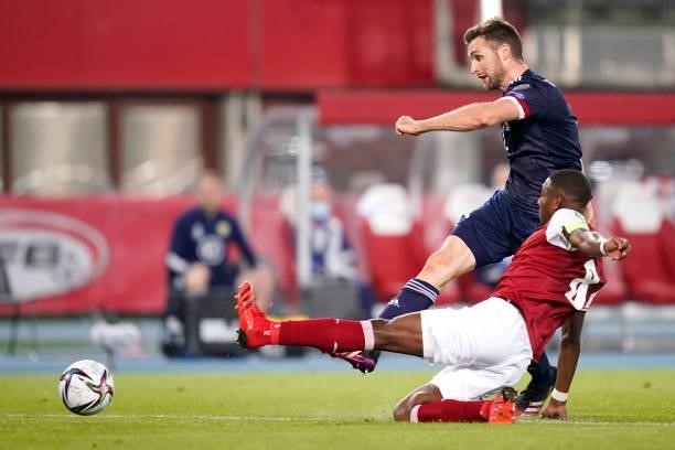 Stephen O'Donnell of Scotland shoots whilst under pressure from David Alaba of Austria during the 2022 FIFA World Cup Qualifier match between Austria...