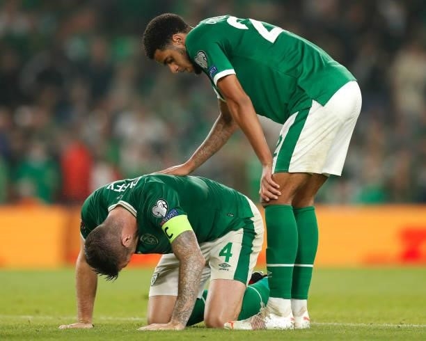 Shane Duffy of Republic of Ireland appears to be injured as Andrew Omobamidele of Republic of Ireland checks on him during the 2022 FIFA World Cup...