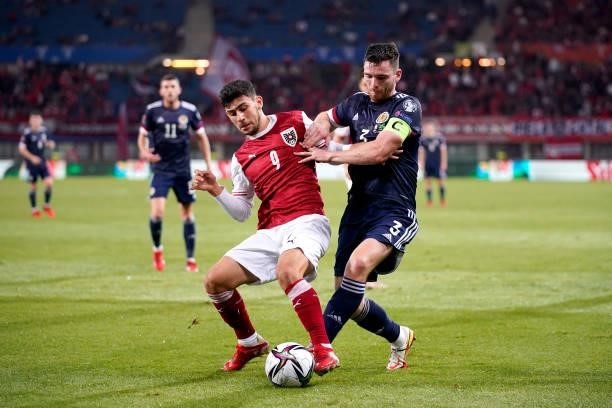 Yusuf Demir of Austria battles for possession with Andy Robertson of Scotland during the 2022 FIFA World Cup Qualifier match between Austria and...