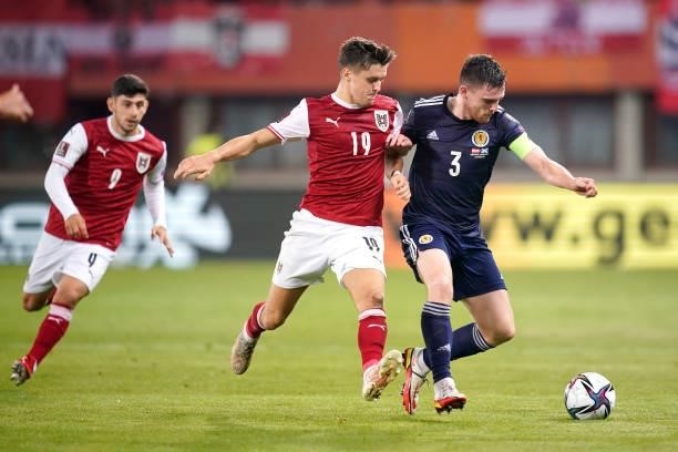 Andy Robertson of Scotland is challenged by Christoph Baumgartner of Austria during the 2022 FIFA World Cup Qualifier match between Austria and...