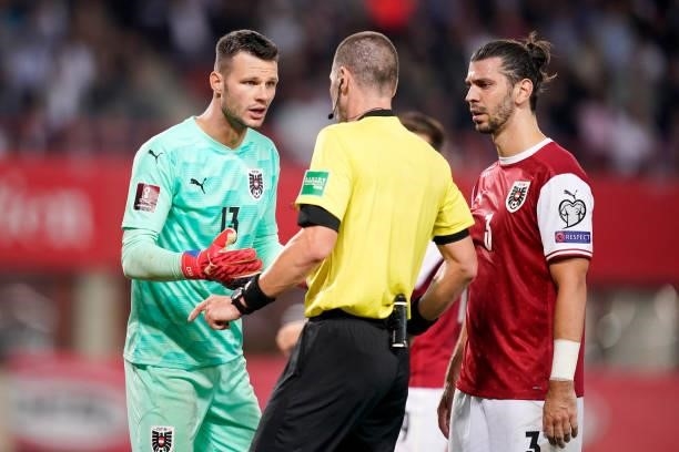 Daniel Bachmann of Austria interacts with Match Referee, Georgi Kabakov during the 2022 FIFA World Cup Qualifier match between Austria and Scotland...