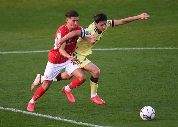 Charlie Patino of Arsenal takes on Ricky Aguiar of Swindon during the Football League Trophy group N match between Swindon Towna and Arsenal U21 at...