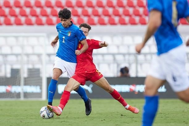 Raoul Bellanova of Italy competes for the ball with Omar Sijaric of Montenegro during the UEFA European Under-21 Championship Qualifier between Italy...