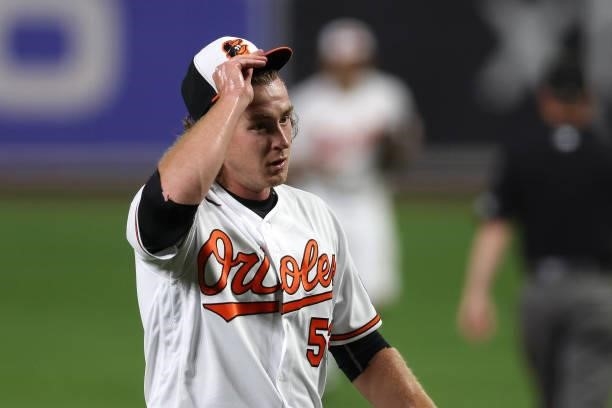 Mike Baumann of the Baltimore Orioles walks off the mound after retiring the Kansas City Royals during his MLB debut in the fifth inning at Oriole...
