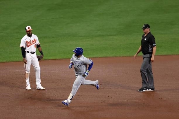 Carlos Santana of the Kansas City Royals rounds the bases in front of Kelvin Gutierrez of the Baltimore Orioles after hitting a fourth inning solo...